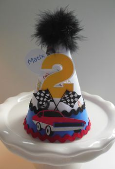 a birthday hat with a number 2 on it and a car decoration around the top