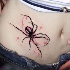 a woman's stomach with a spider tattoo on it