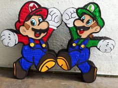 two paper mario brothers standing next to each other