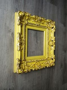 an old yellow frame hanging on the wall