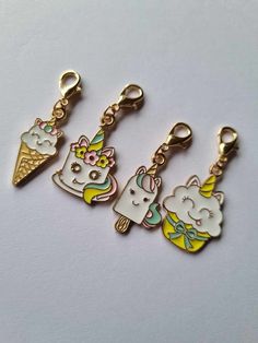 three key chains with unicorns and ice cream on them, one is gold plated