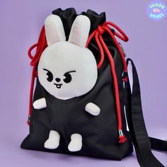 Do you want to carry your Skzoo with your hands free? 🙌 Put your Skzoo plushie in our newest carrier bag! It is all handmade! 🪡 No more missing or dropping Skzoos! 🤩  Dimensions: 2.5 / 8 / 12 inches or 6 / 20 / 30 centimeters Colors: Black, red and silver. Material: Ripstop waterproof fabric, cotton rope, steel accessories.  Handle is adjustable. It has a mini pocket inside. **This is only a carrier bag. Plushies are not included.** Novelty Black Standard Backpack, Black Novelty Standard Backpack, Harajuku Style Pouch Bag, Concert Bag, Bts Bag, Concert Bags, Skz Concert, Kids Purse, Steel Accessories