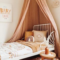 a bed with a canopy over it in a bedroom