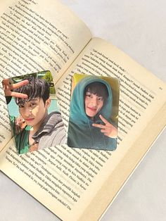 an open book with two pictures of people on the pages and one is pointing at something