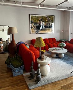 a living room filled with furniture and a painting on the wall