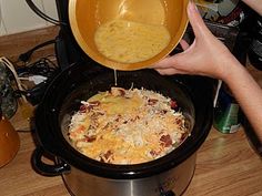 someone is pouring cheese into a crock pot