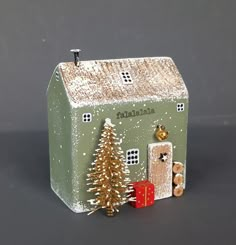 a small green house with a christmas tree