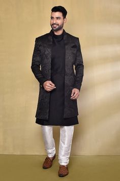 Blackish blue nawabi jacket with woven leaf patterns. Comes with sleeveless pintucked kurta and white churidar. - Aza Fashions Designer Black Outerwear For Wedding, Designer Long Sleeve Sherwani For Fall, Designer Long Sleeve Bandhgala For Fall, Traditional Black Outerwear With Stand Collar, Traditional Black Stand Collar Outerwear, Festive Black Outerwear With Stand Collar, Fall Festive Nehru Jacket, Festive Black Long Sleeve Outerwear, Black Festive Winter Outerwear