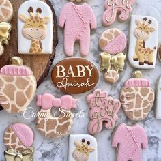 baby shower cookies decorated with giraffes and other items