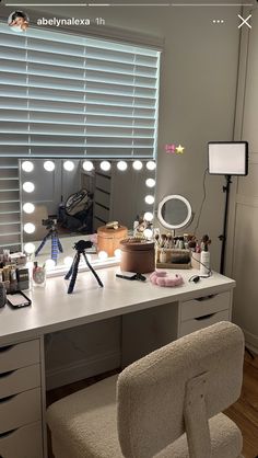 a chair sitting in front of a desk with a mirror and lights on top of it