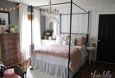 a canopy bed in a bedroom with pink and white decor