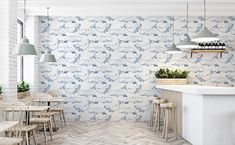 the interior of a restaurant with blue and white wallpaper, wooden tables and chairs