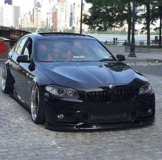 a black car parked in front of a city street