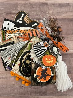 a pile of assorted halloween decorations on top of a wooden floor