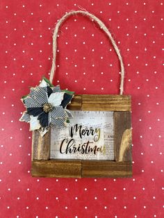 a wooden sign hanging on a red wall with white polka dotty fabric and twine