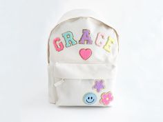 Custom Nylon Backpack with Chenille Letters Personalized backpack with patch letters Travel Bag, Easter, Teacher gift girls Back to school  Introducing our delightful collection of backpacks, specially designed for young adventurers and ideal for kindergarten and young children. Crafted with utmost care and attention to detail, these backpacks offer the perfect blend of comfort, safety, and style to make every day a joyful exploration. The total number of patches required includes both letters a Trendy Embroidered School Backpack, White School Bags With Letter Embroidery, Pink School Bag With Letter Patch, Pink School Bags With Letter Patch, School Bag With Letter Patch For Back To School, School Bags With Letter Patch For Back To School, Back To School Bags With Letter Patch, School Backpack With Embroidered Patch, School Backpack With Letter Embroidery