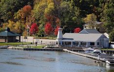 the boat dock is surrounded by colorful trees