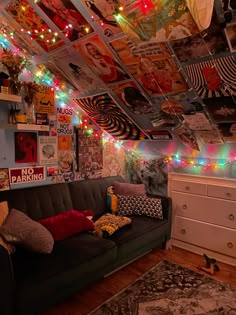 a living room filled with furniture and lots of lights hanging from the ceiling above it