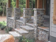 an outdoor patio with stone pillars and steps