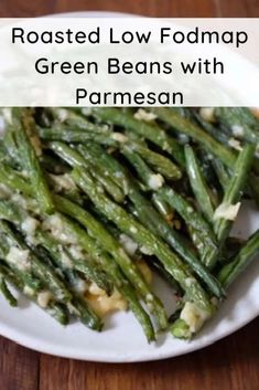 roasted low fodmap green beans with parmesan on a white plate