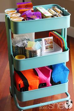 a cart filled with lots of items on top of a hard wood floor