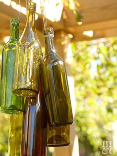 three empty wine bottles hanging from a string