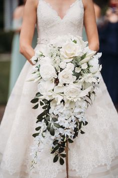 a bridal holding a bouquet of white flowers