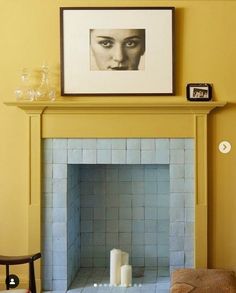 a living room with a fireplace and pictures on the wall