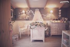 a baby's room decorated in white and grey