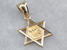 This Star of David medal has very fine detail! Crafted of yellow gold and sized and styled for either sex, this pendant would make a lovely religious-themed gift! This pendant does not come with the chain shown. Please feel free to contact us, we will help you find the perfect chain for your style and budget! Metal: 10K/14K Yellow Gold Measures: 14 x 21 mm, with bail Marks: "10K 14KMa" Stamped Jewish Star, Bat Mitzvah Gifts, Star Of David, Eternity Bands, Ring Holder, Gold Pendant, Jewelry Necklace Pendant, Bat, Perfume Bottles