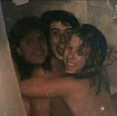 two people are hugging in the bathtub