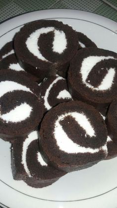 chocolate cookies with white frosting on a plate