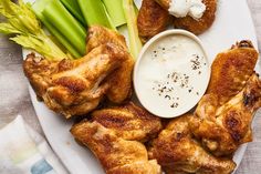 chicken wings and celery on a plate with ranch dressing