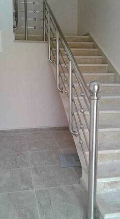 a stair case next to a set of stairs in a room with tile flooring