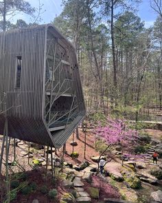 a wooden structure sitting in the middle of a forest