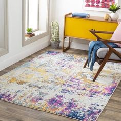 a living room with a colorful rug and chair