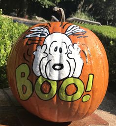 a pumpkin with the words boo painted on it