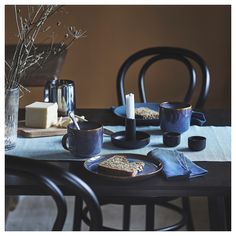 a table topped with plates and cups filled with food