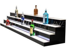 three tiered shelf with bottles on each side and one empty bottle in the middle