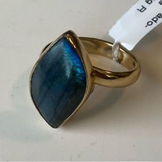 Natural Deep Blue Labradorite Alchemia Gold Ring. Adjustable 3mm Ring Shank, Fits All Ring Sizes 5 6 7 8 9 10 Handcrafted In Taxco Mexico By Skilled Fair Trade Artisans. Lead Free, Nickel Free, Hypoallergenic. Baked Lacquer Finish To Protect Metal From Turning Or Tarnishing. Alchemia Gold Rings: Alchemia Gold Or Zero Karat Gold Infuses A Blend Of Base Metals To Simulate The Look And Feel Of 18k Gold, But With An Affordable Price. Alchemia Is Not Plated So The Color Is Through & Through. Blue Moonstone Rings With Natural Stones, Blue Moonstone Rings As A Gift, Blue Moonstone Rings Perfect For Gifts, Blue Labradorite Ring, Blue Labradorite Moonstone Ring, Gift Blue Labradorite Rings, Blue Labradorite Rings As Gift, Blue Round Labradorite Jewelry, Blue Cabochon 14k Gold Ring