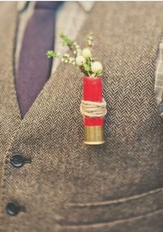 a man wearing a suit and tie with a boutonniere on his lapel