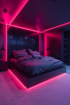 a large bed in a room with pink lighting