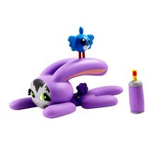 an inflatable toy cat laying on its back next to a tube of glue