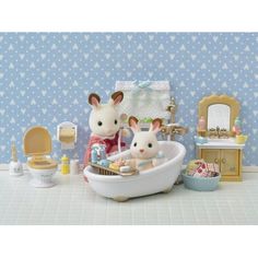 two toy mice in a bathtub with blue wallpaper