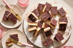 several pieces of cake on plates with forks