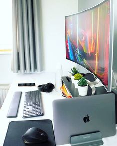 an apple computer sitting on top of a white desk