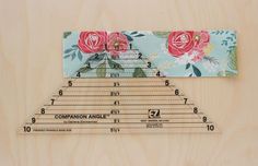 a ruler with flowers on it sitting next to a piece of paper that says companion angle