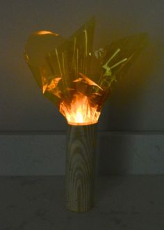 a vase that has some kind of fire in it's center and is lit up