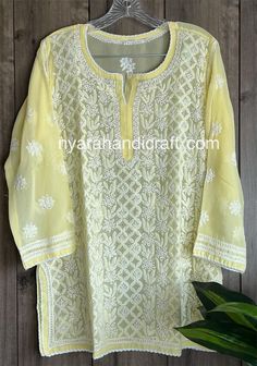 Chikankari hand embroidered kurti top on georgette.  Intricate hand embroidery with 'Mukaish' add ons.  Length: 30 inches Sleeves: 3/4 th Liner included Diwali Georgette Tops With Zari Work, Festival Tops With Resham Embroidery In Georgette, Designer Chikankari Embroidery Blouse For Eid, Traditional Georgette Tops With Zari Work, Georgette Tops With Chikankari Embroidery For Wedding, Wedding Tops With Chikankari Embroidery On Georgette, Traditional Georgette Tops For Festivals, Embroidered Anarkali Georgette Top, Anarkali Blouse With Chikankari Embroidery In Georgette