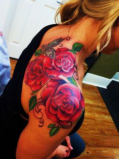 a woman's stomach with roses and a humming on it, painted in red